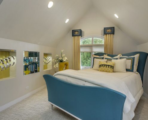 To pull together the color palette of this bedroom, we custom designed blue and gold pillows. Photo by www.lmphotography.com