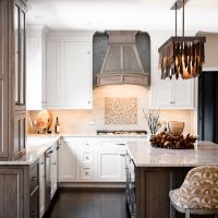 A cozy kitchen design has two-toned cabinets in white and rustic cool ash wood for greater dimension