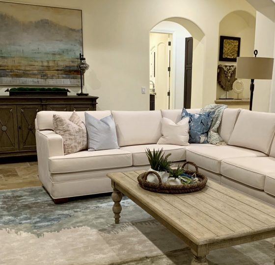 great room, sectional sofa, cocktail table, rug, pillows, wall art, chest, accessories