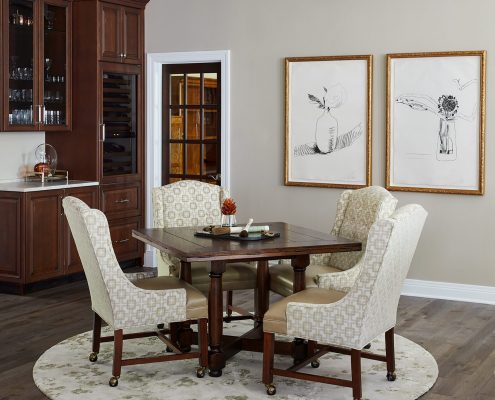 game table, arm chairs, round rug, square table, wall art, wet bar