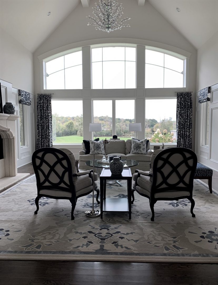 traditional living room, cahirs, end table, sofa, rug, window panels, chandelier, window wall, accessories