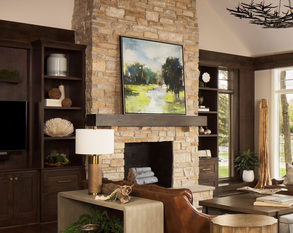 great room, stone fireplace, cabinets, leather sofas, console table, table lamp, cocktail table, side table, ottomans, arm chair, rug, accessories, lake view