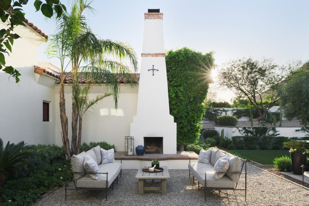 Arizona patio, metal and cushioned furniture, cocktail table, pillows, white outdoor fireplace