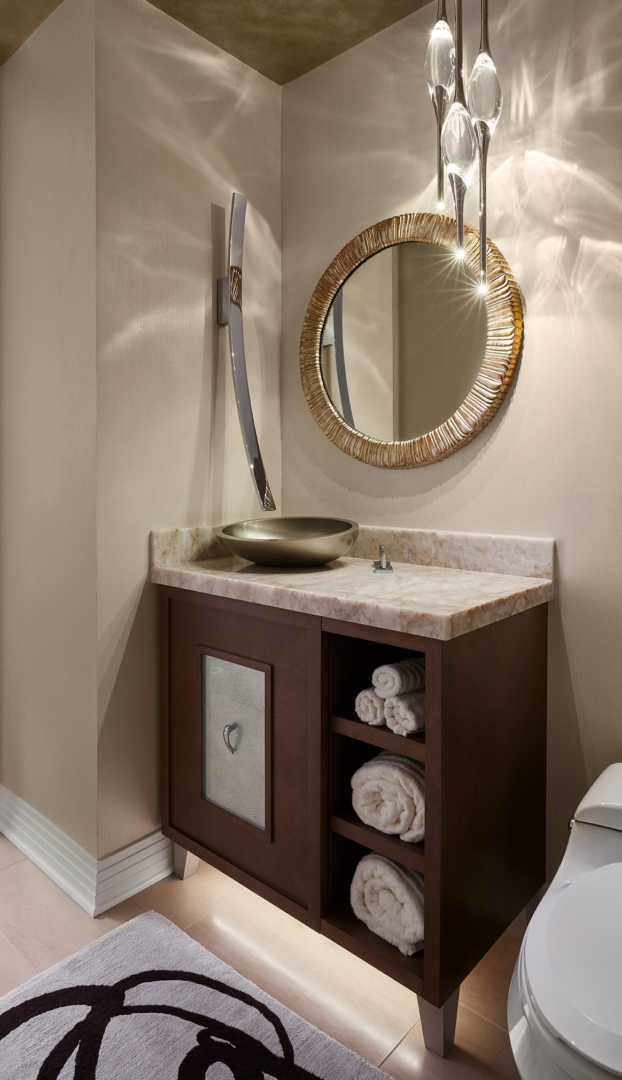powder room, wall-mounted water spout, round wall mirror, stained wood vanity, polished nickel pendants 
