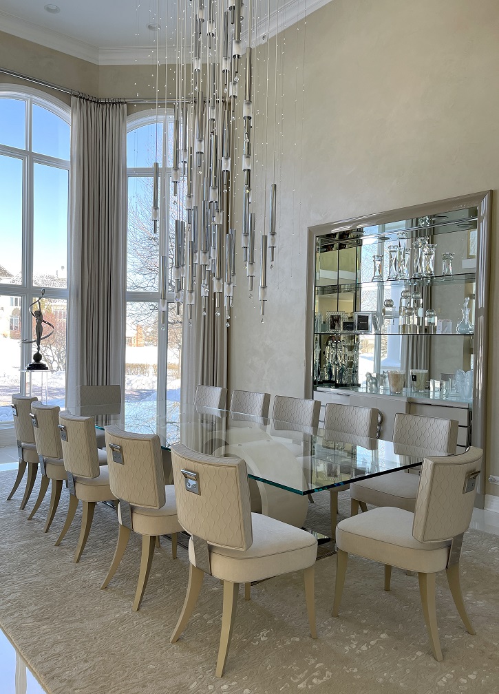 chrome and crystal chandelier, dining room, two-story dining room, glass-topped table, soft white chairs, window treatments 